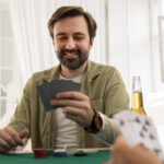 close-up-person-playing-poker-with-friends-scaled.jpg